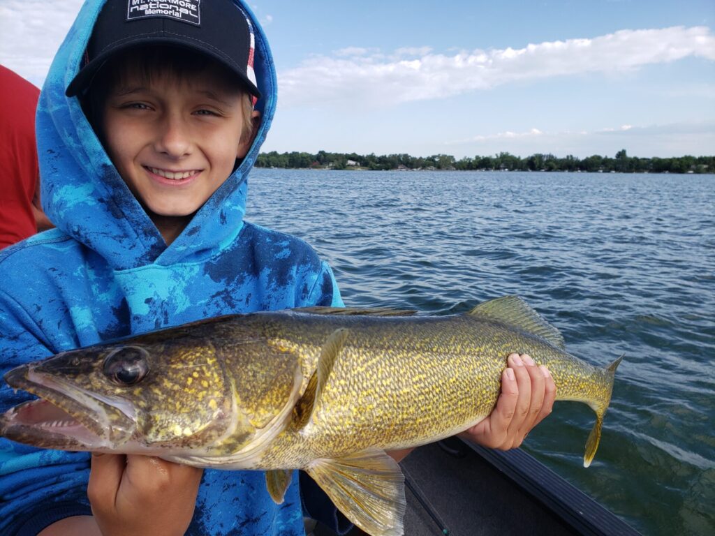 Hungry fish, young angler holding up a nice Walleye!