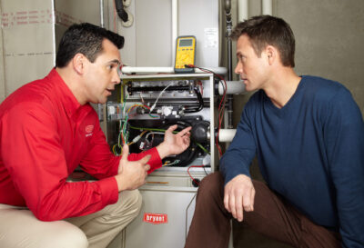 Dealer and Homeowner talking by Furnace