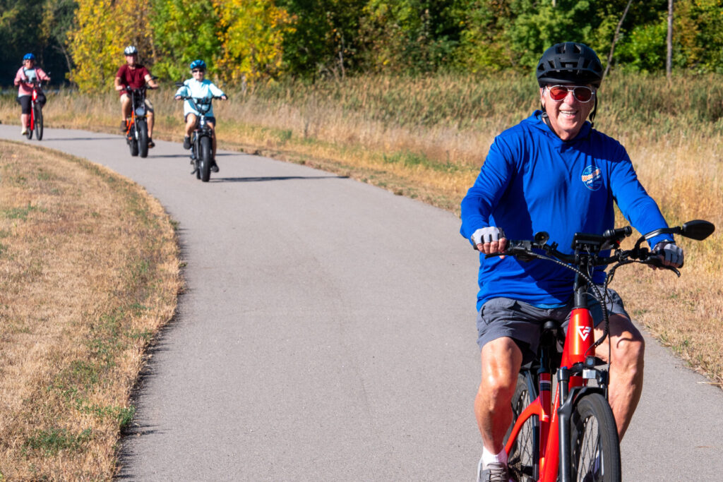 family riding bikes on Heart of the Lakes trail