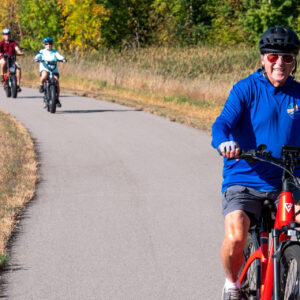 family riding bikes on Heart of the Lakes trail