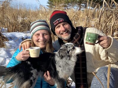 couple with dog and coffee mugs