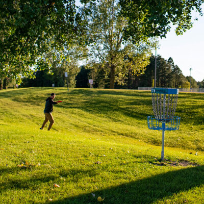 man playing discgolf at a park