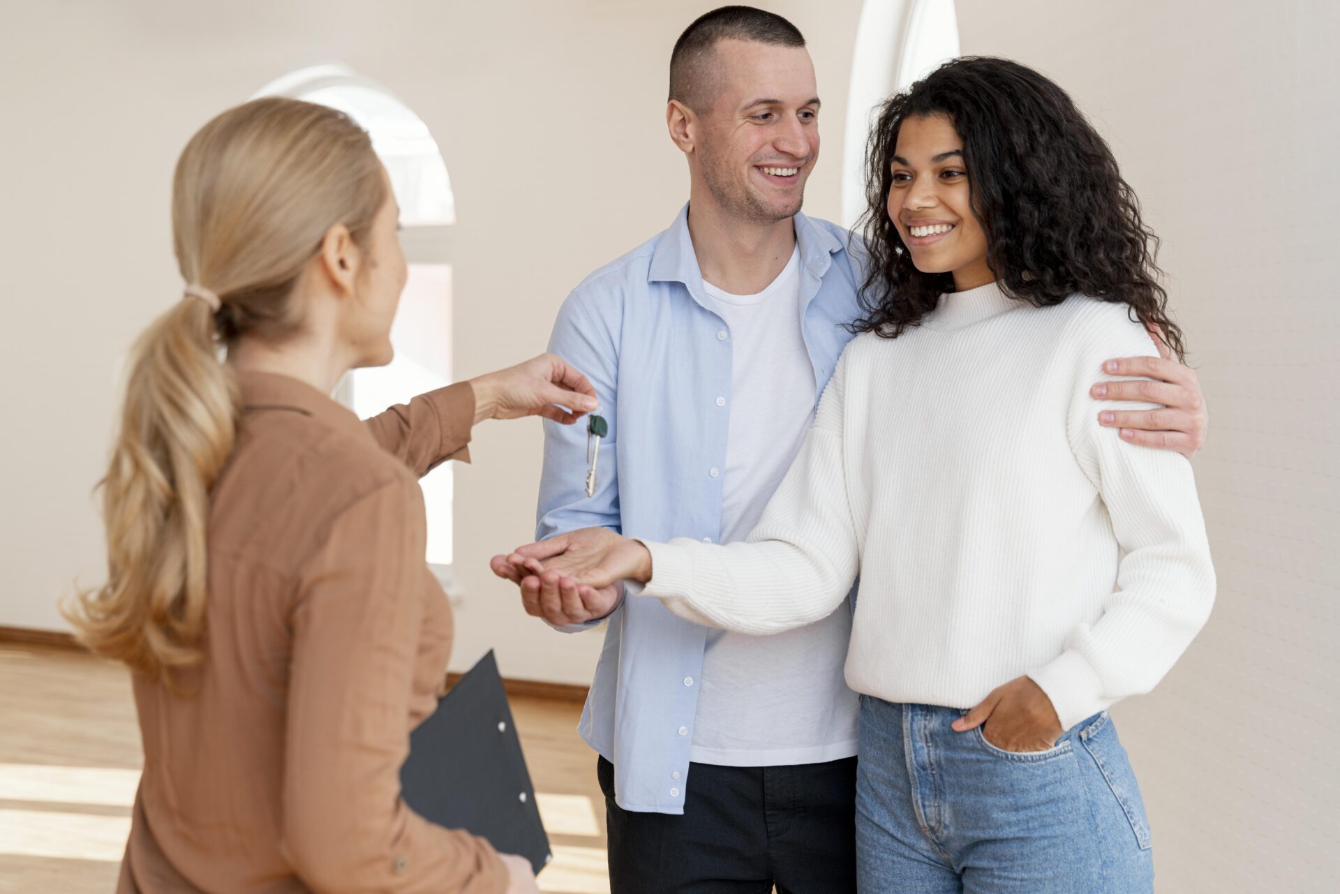 homebuyer couple getting keys to new house