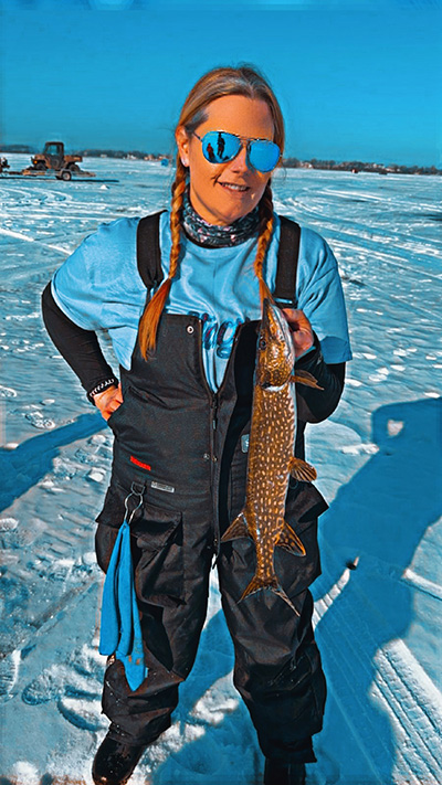 woman holding a fish from ice fishing