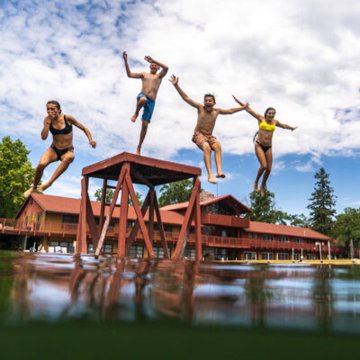 Kids jumping into the lake during the summer