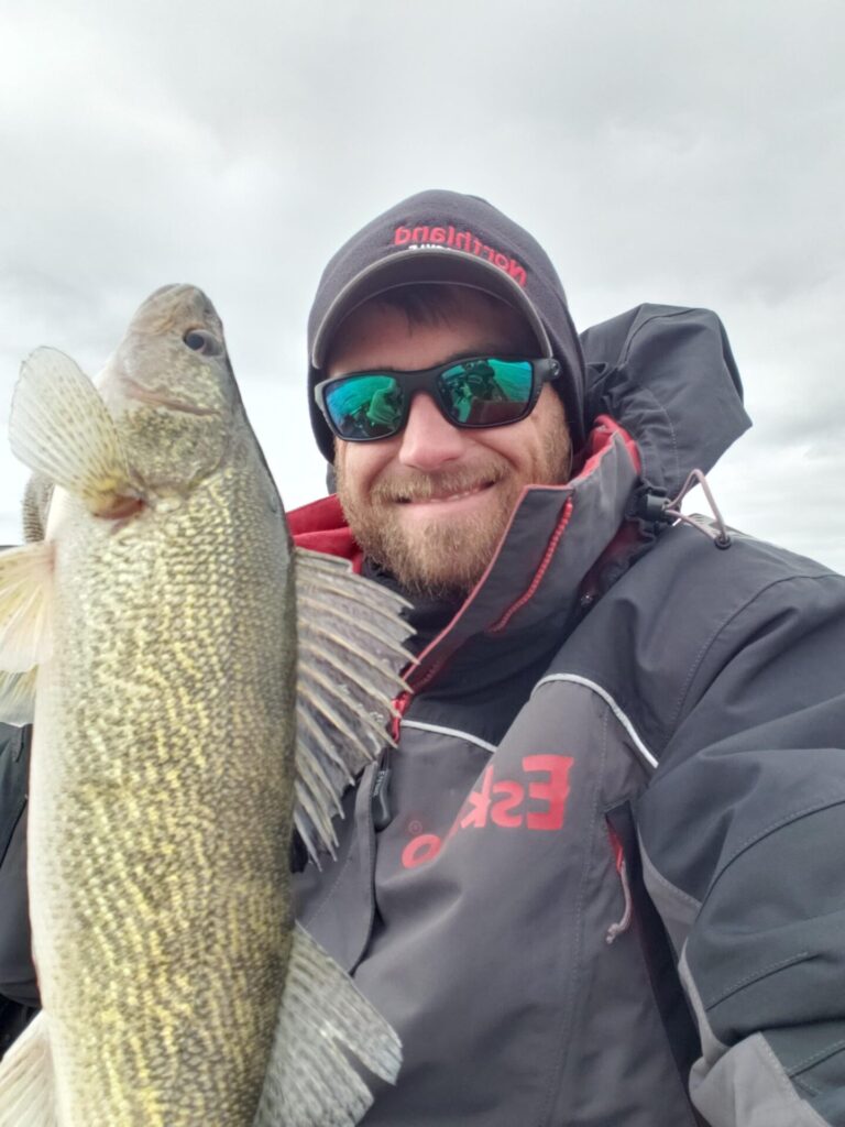 Man holding up a walleye he caught